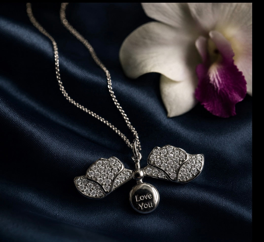 White Gold Dendrobium orchid locket necklace with pave petals and secret message engraving