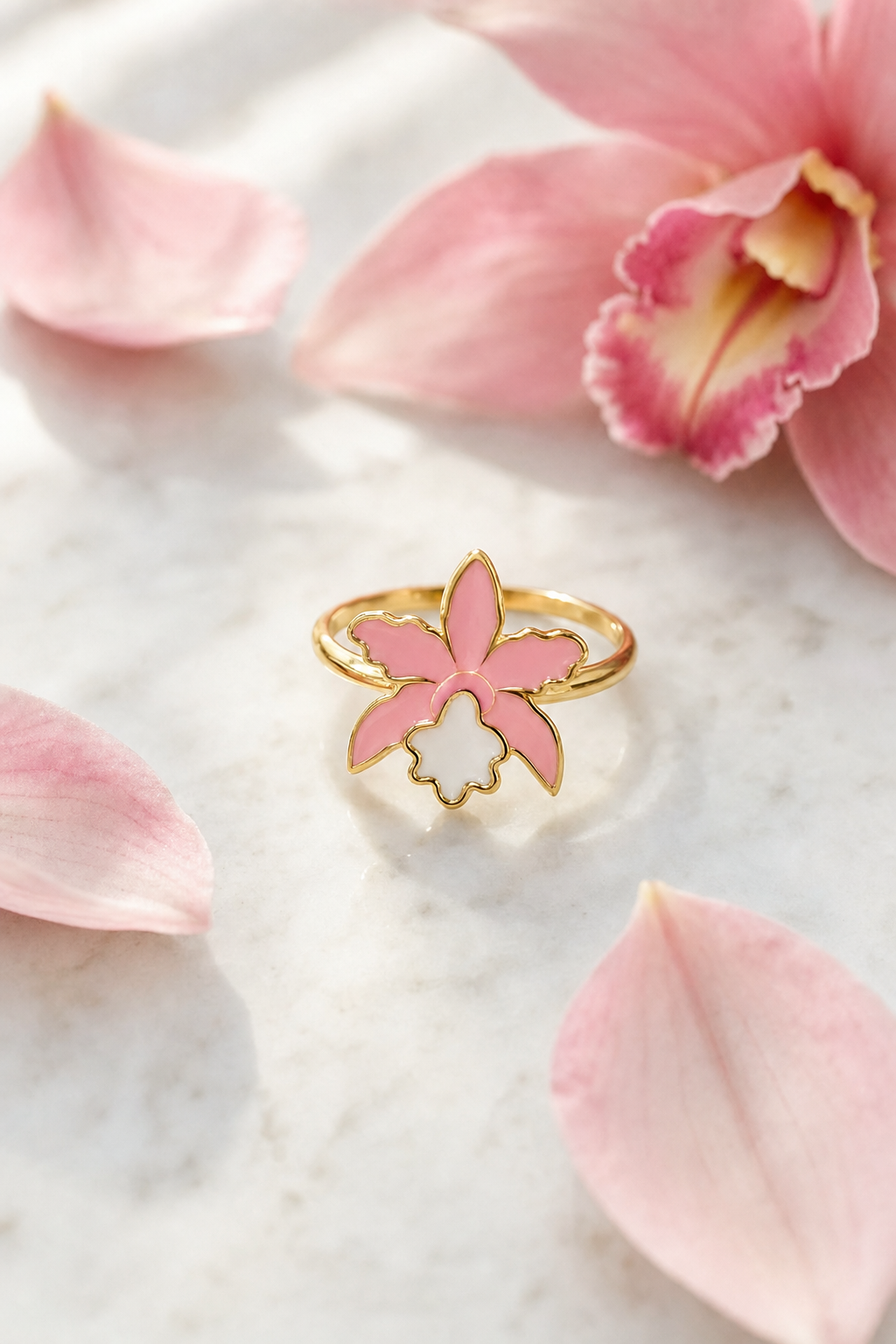 La Colombiana Collection Soft Pink & White Cattleya Orchid Ring on marble with petals - Orchidique