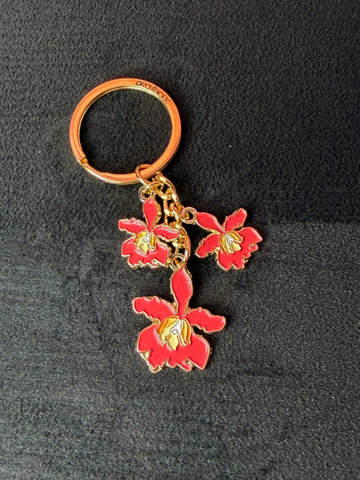 myrmecophila orchid bag charm, red enamel, zinc alloy, another view – Orchidique