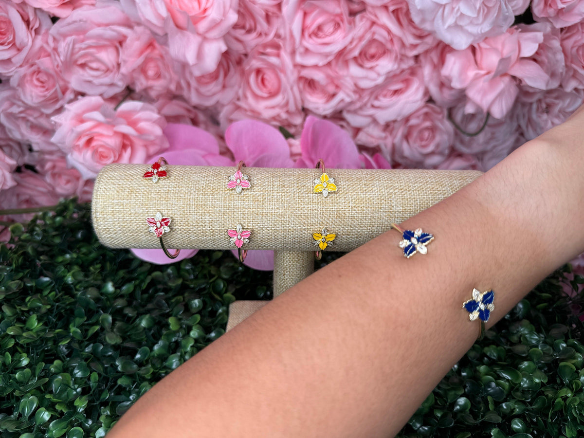 Navy enamel Cattleya orchid open cuff bangle worn on the wrist