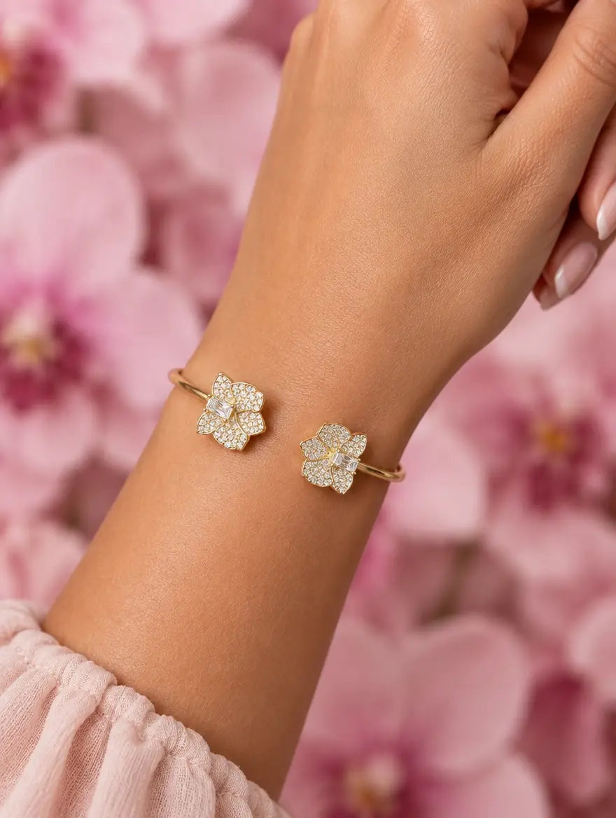dendrobium orchid bangle, shimmer, clear, 14K gold plated sterling silver, worn on wrist close-up – Orchidique