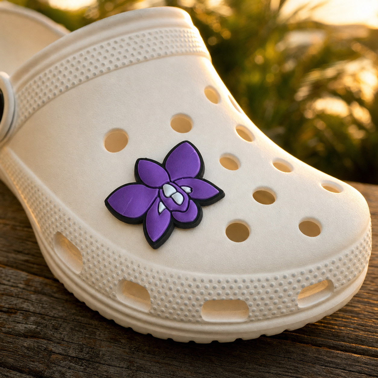 Purple Dendrobium orchid clog charm close-up on white rubber clog at golden hour - Orchidique