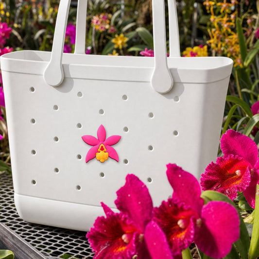 Hot pink Cattleya orchid PVC tote bag charm on white tote with orchids