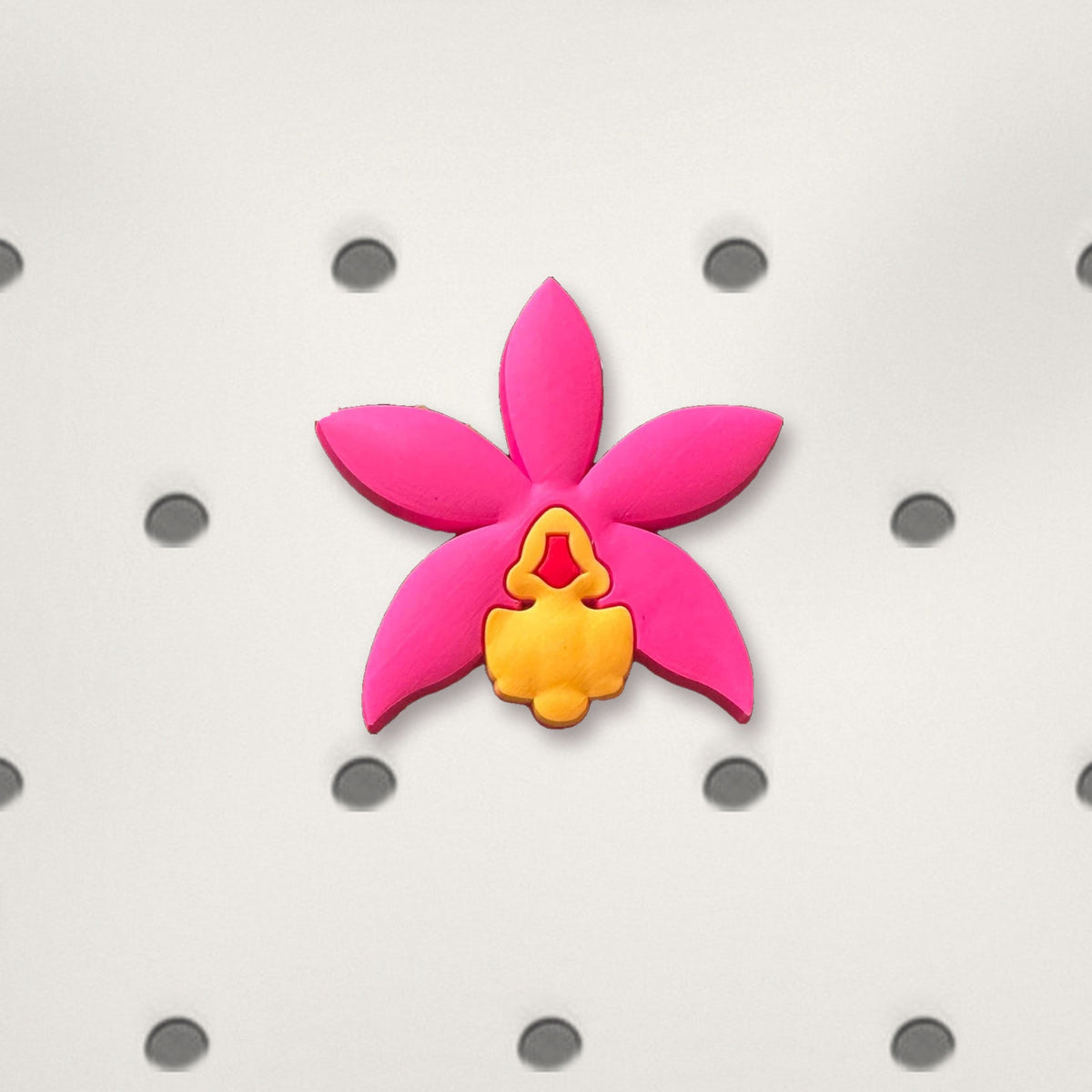 Hot pink Cattleya orchid PVC tote bag charm close-up on white bag