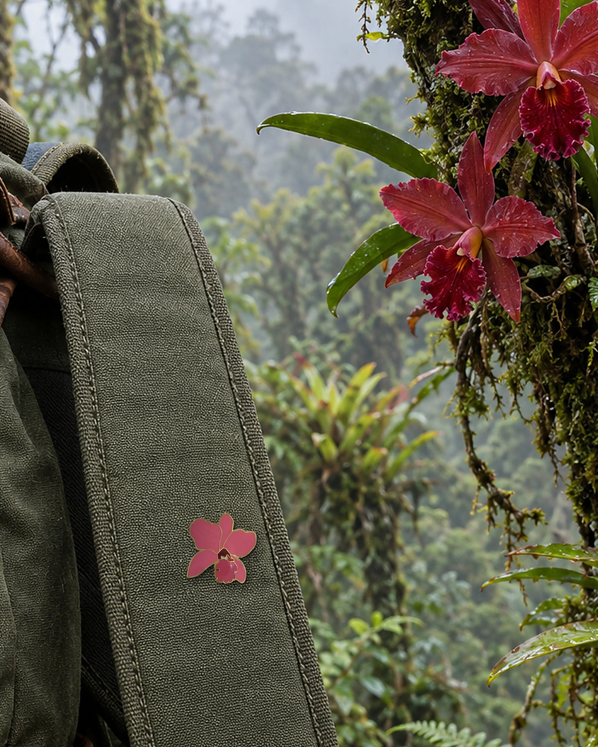 Coral-rose Lueddemannia orchid enamel pin on a canvas backpack strap in a misty cloud forest beside wild orchids