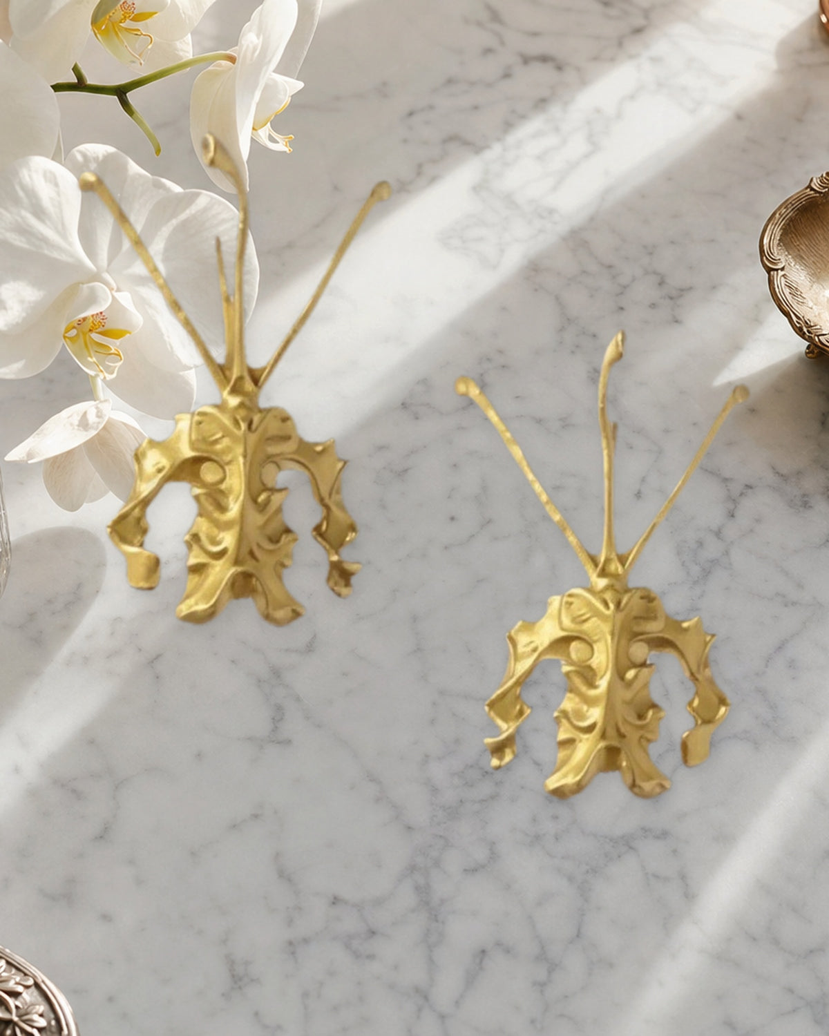 Psychopsis Butterfly Orchid earrings pair on marble with white Phalaenopsis — Orchidique