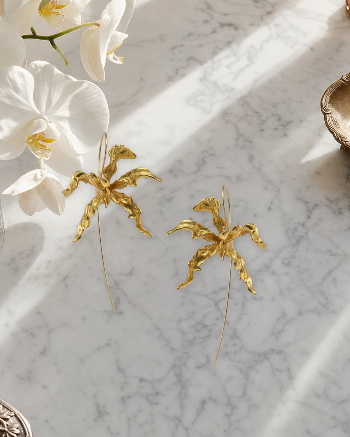 Schomburgkia Orchid Dangle Earrings - gold pair styled on marble