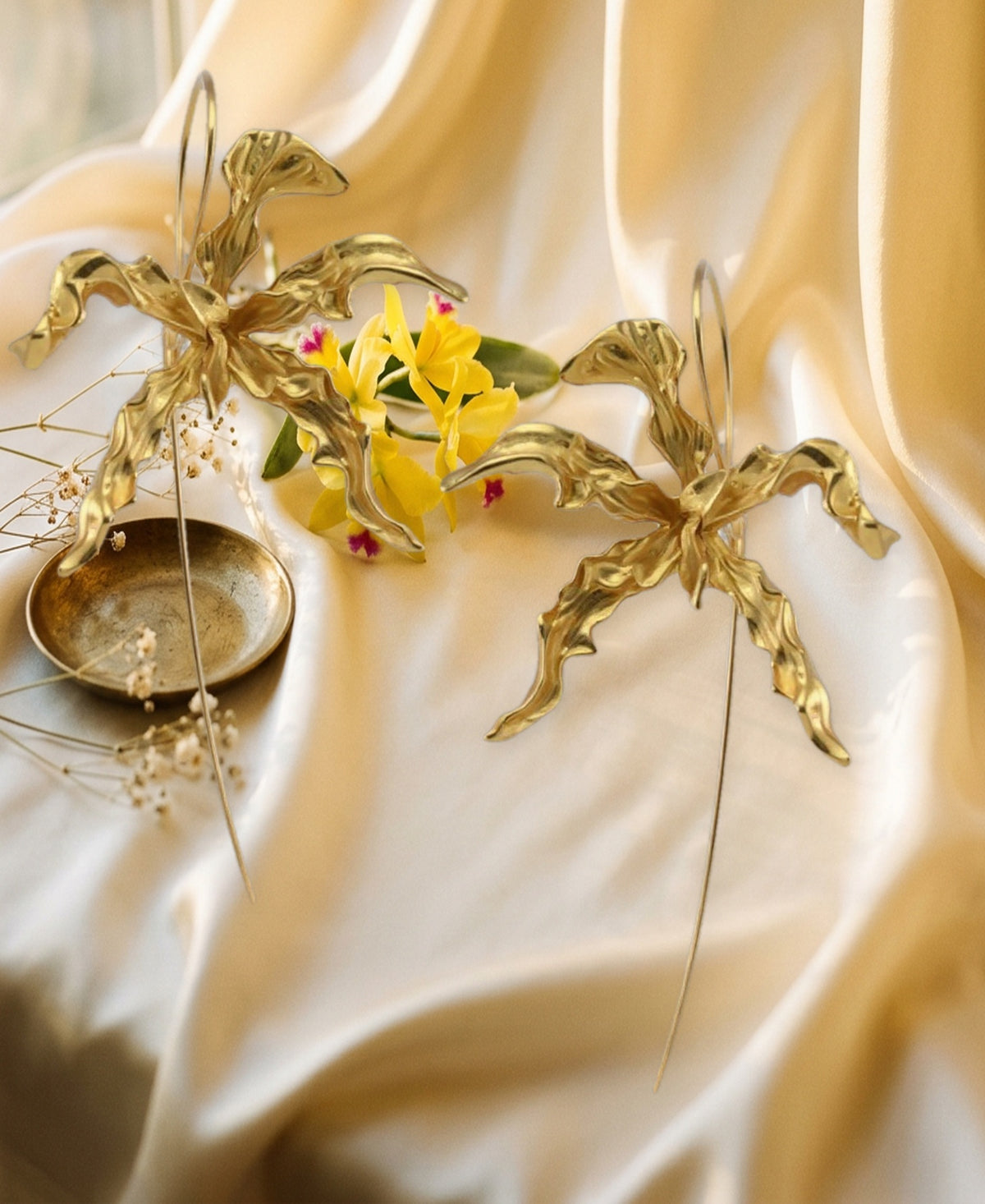 Schomburgkia Orchid Dangle Earrings - gold pair styled on champagne silk