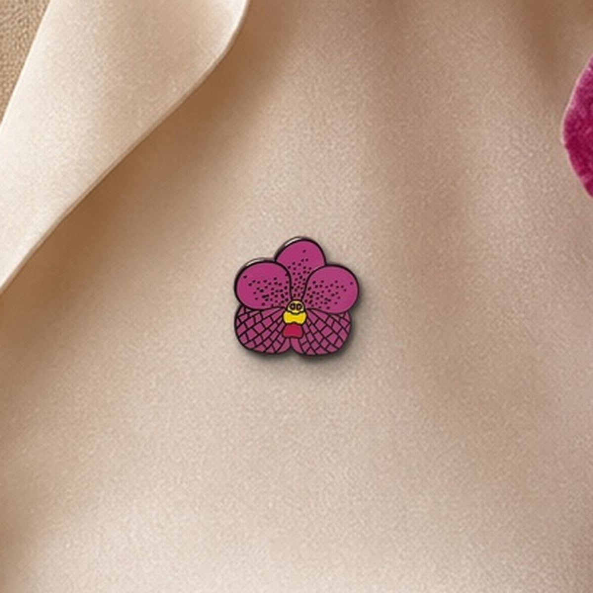 Pink Vanda enamel pin close-up on silk