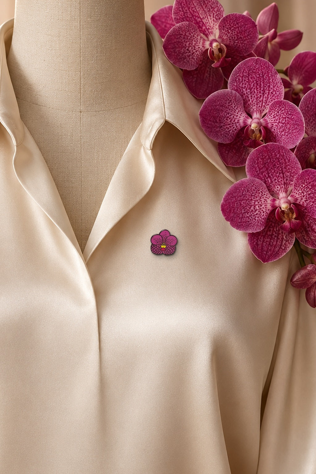 Pink Vanda orchid hard enamel pin on an ivory silk blouse with magenta Vanda blooms