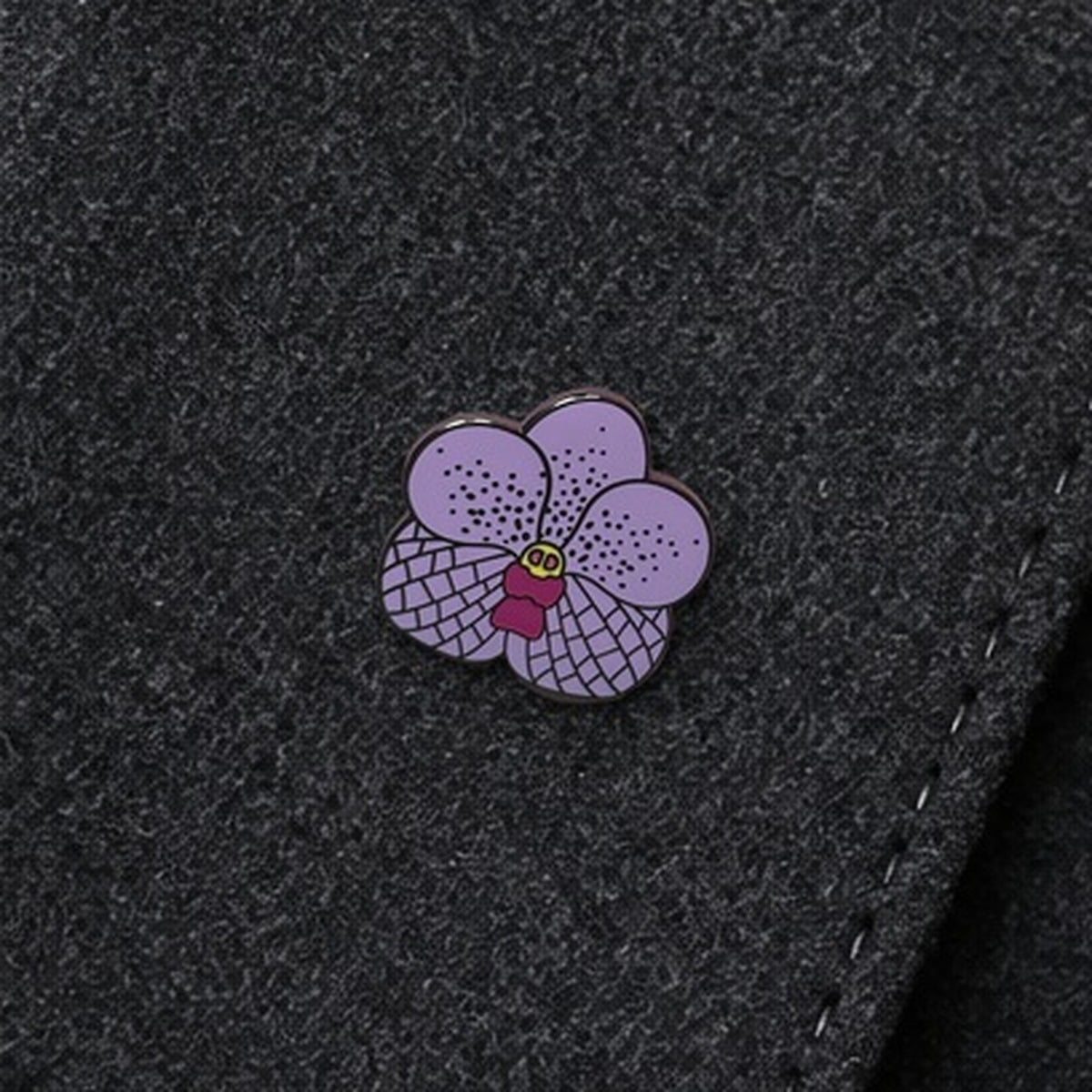 Purple Vanda enamel pin close-up on wool lapel